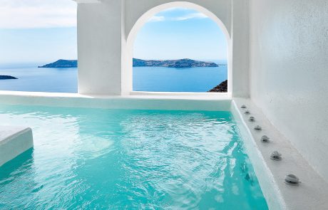 View of the small island of Thirasia through the outdoor pool of Dana Villas & Infinity Suites