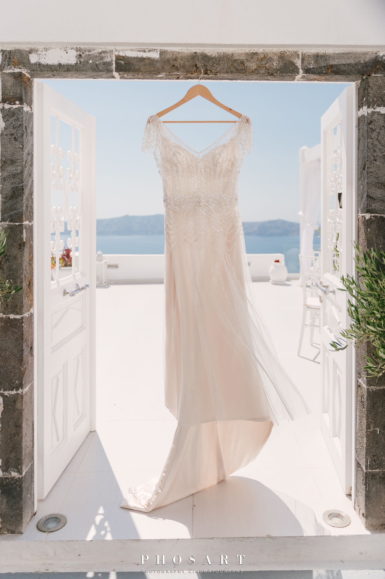 wedding dress hanging on the stone case of Dana Villas main entrance door