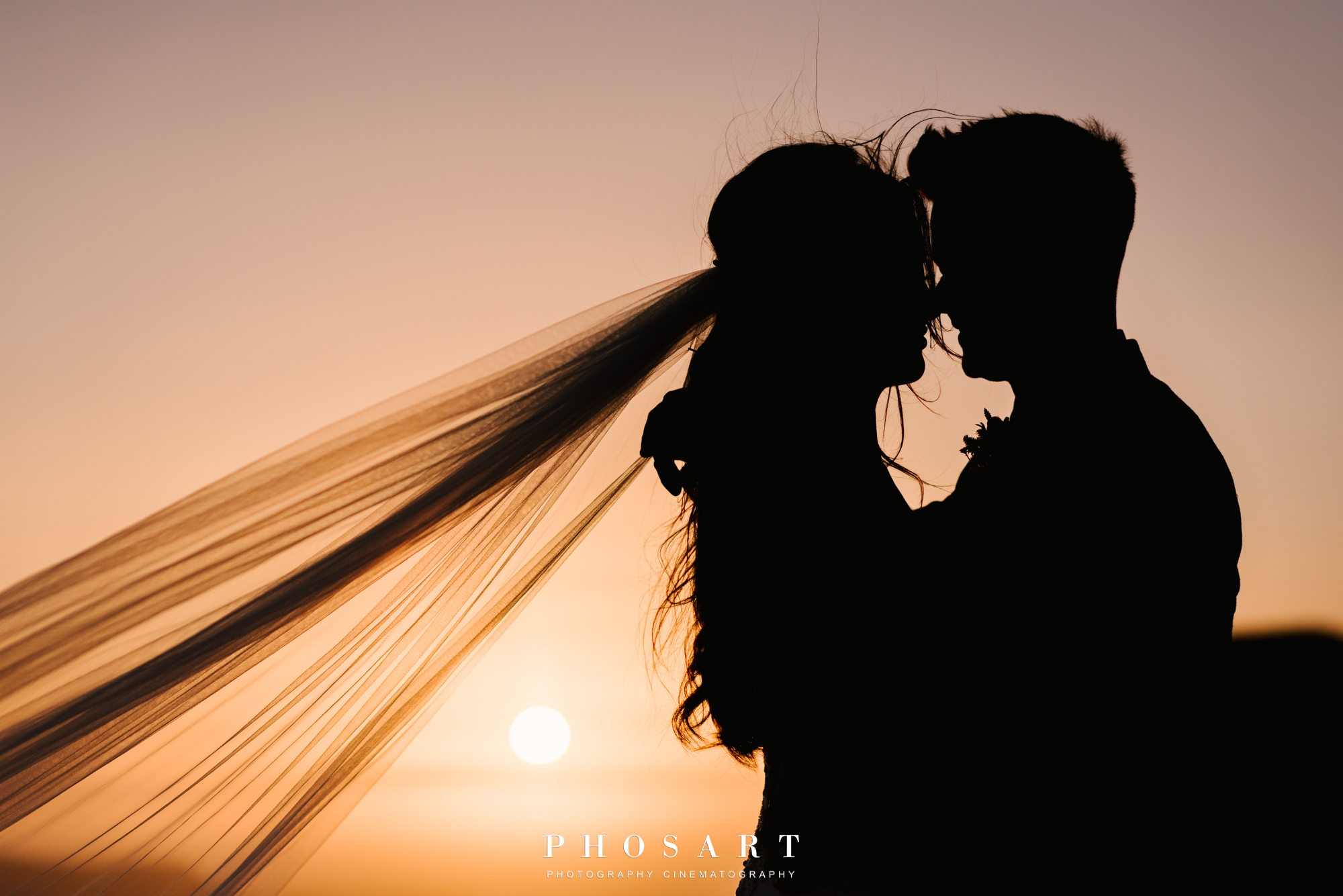 Romantic snapshot of a couple who just got married against the sunset light