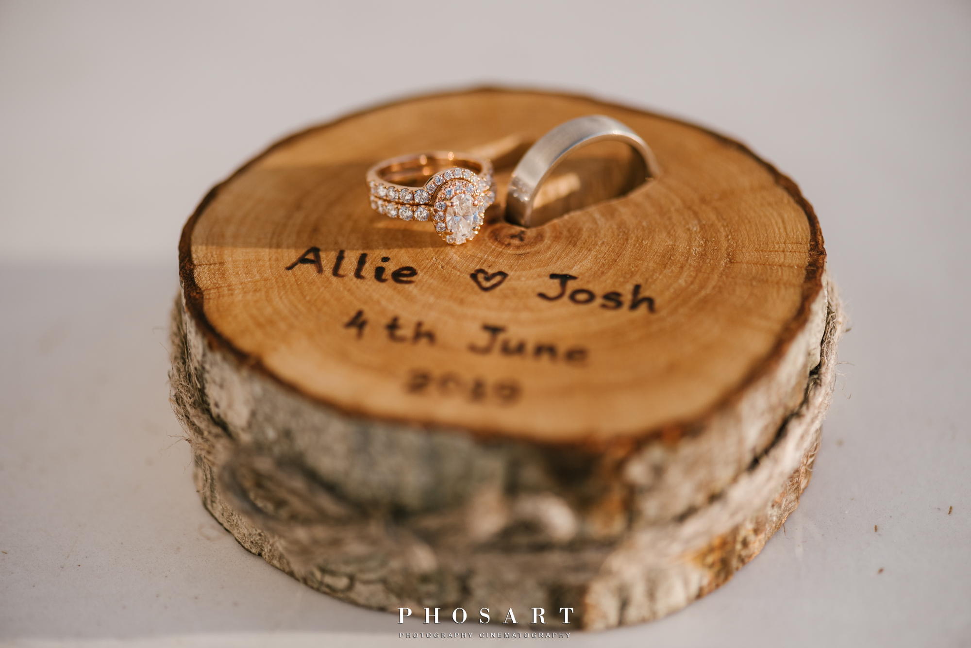 A small cylindrical piece of wood with a diamond ring and a wedding ring on