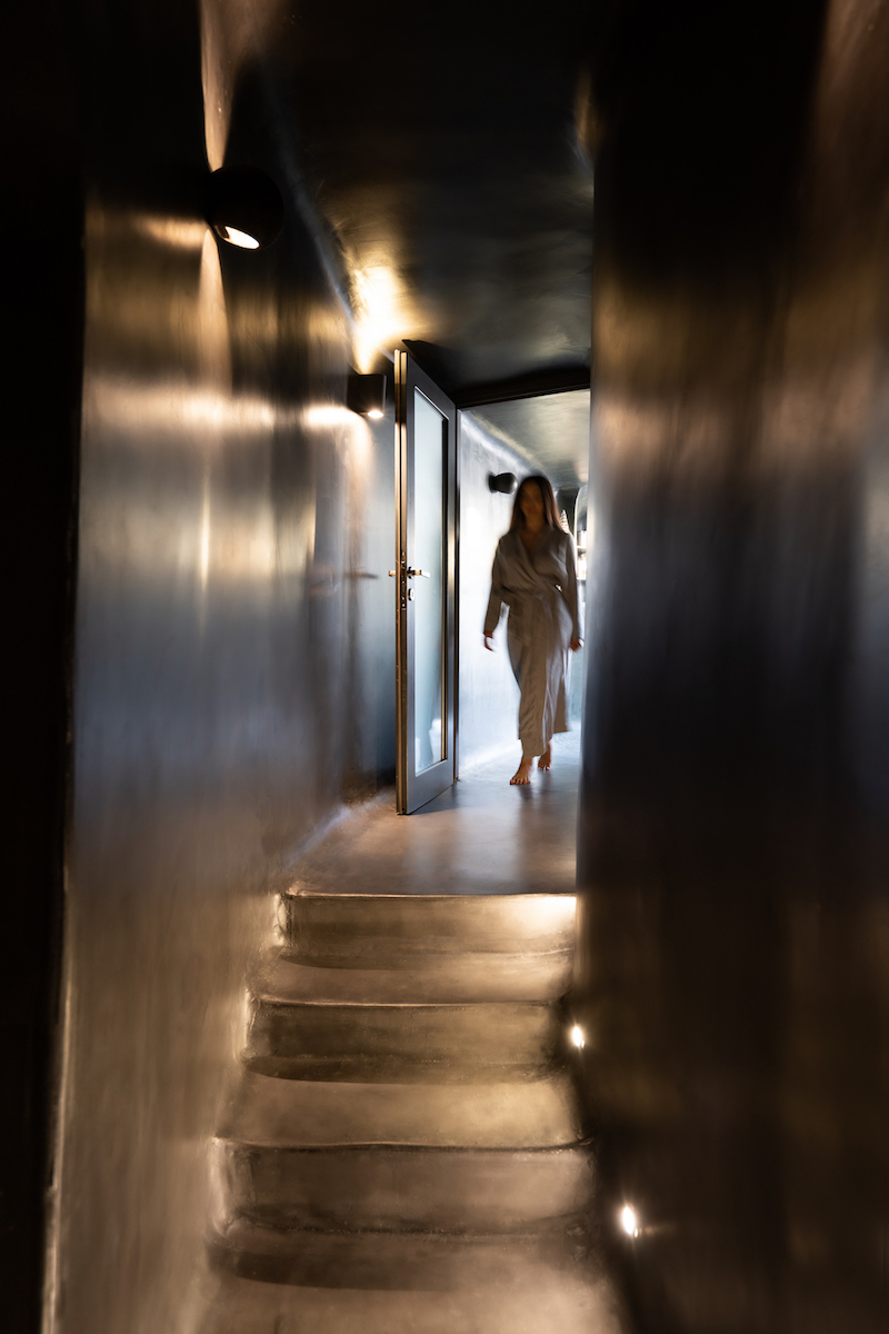 Blurred female figure walks up the internal stairs of Dana Villas Soma Spa