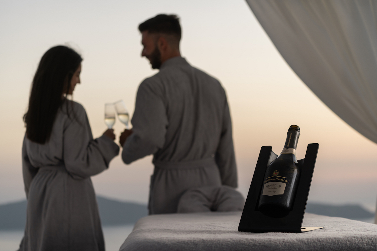 Couple enjoying a glass of Prosecco wine on the terrace of Dana Villas Soma Spa during sunset